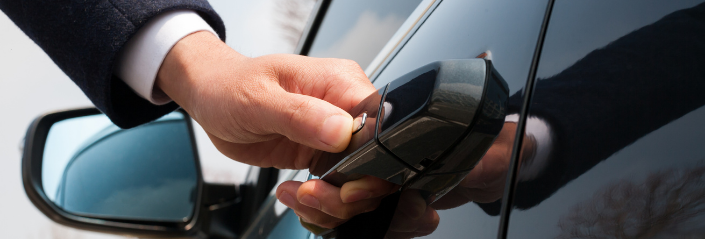 Business person opening car door